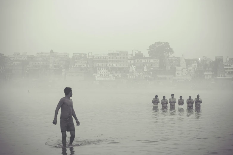 some people on the beach in the water