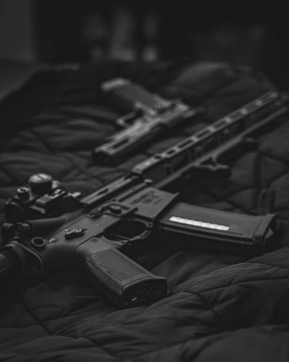 an image of guns and other supplies laid out on the bed