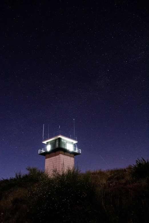 a distant view of a small tower with lights on