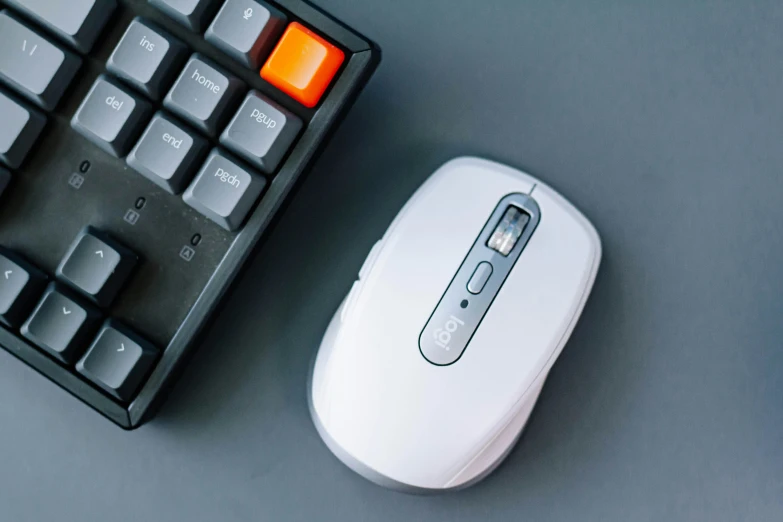 a keyboard, mouse and a mouse pad on a desk