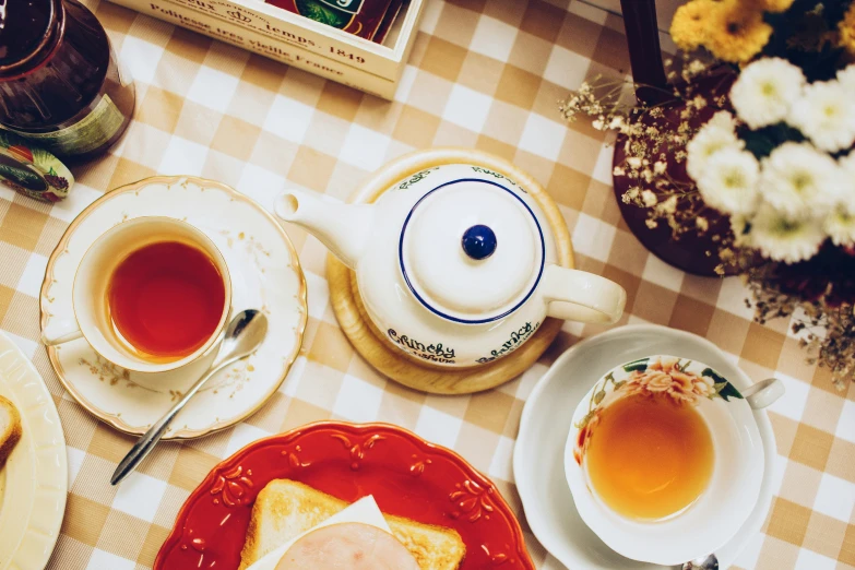 a plate with two different cups and saucers with food