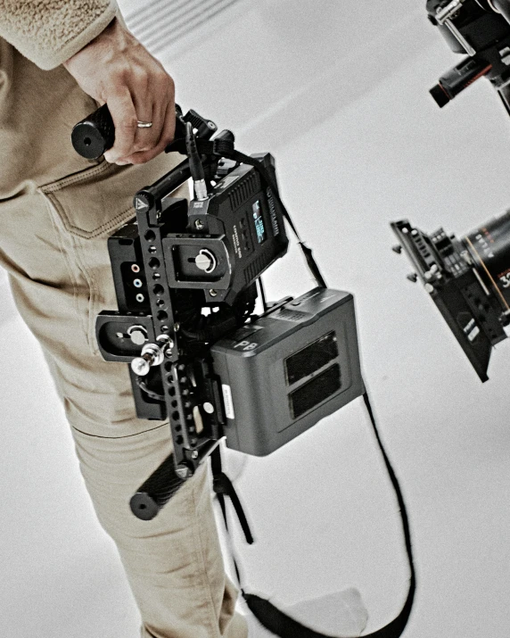a man standing in front of a camera holding a video camera