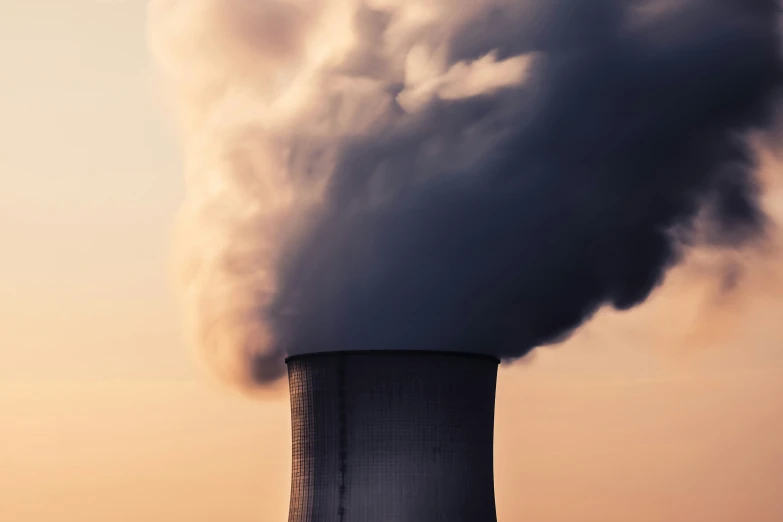 large smokestack with clouds coming out of it