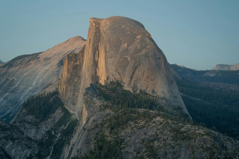 a very tall mountain near some trees