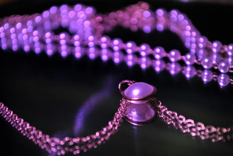 a close - up of a necklace of pearls on a table