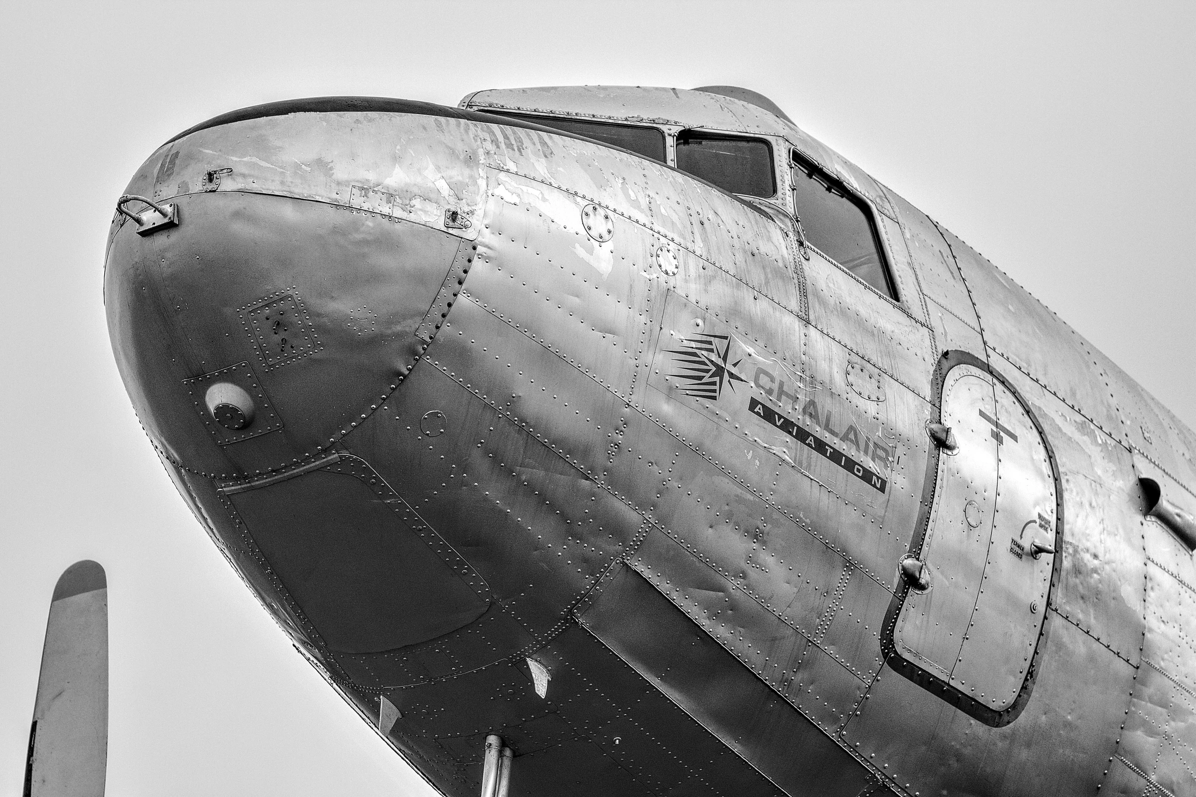 the nose of an old airplane, black and white