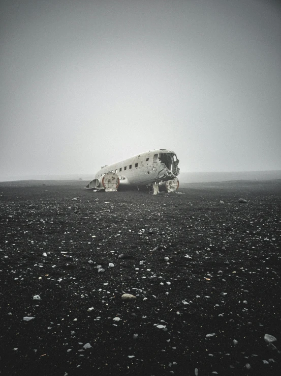 a white space craft sits in the middle of an empty field