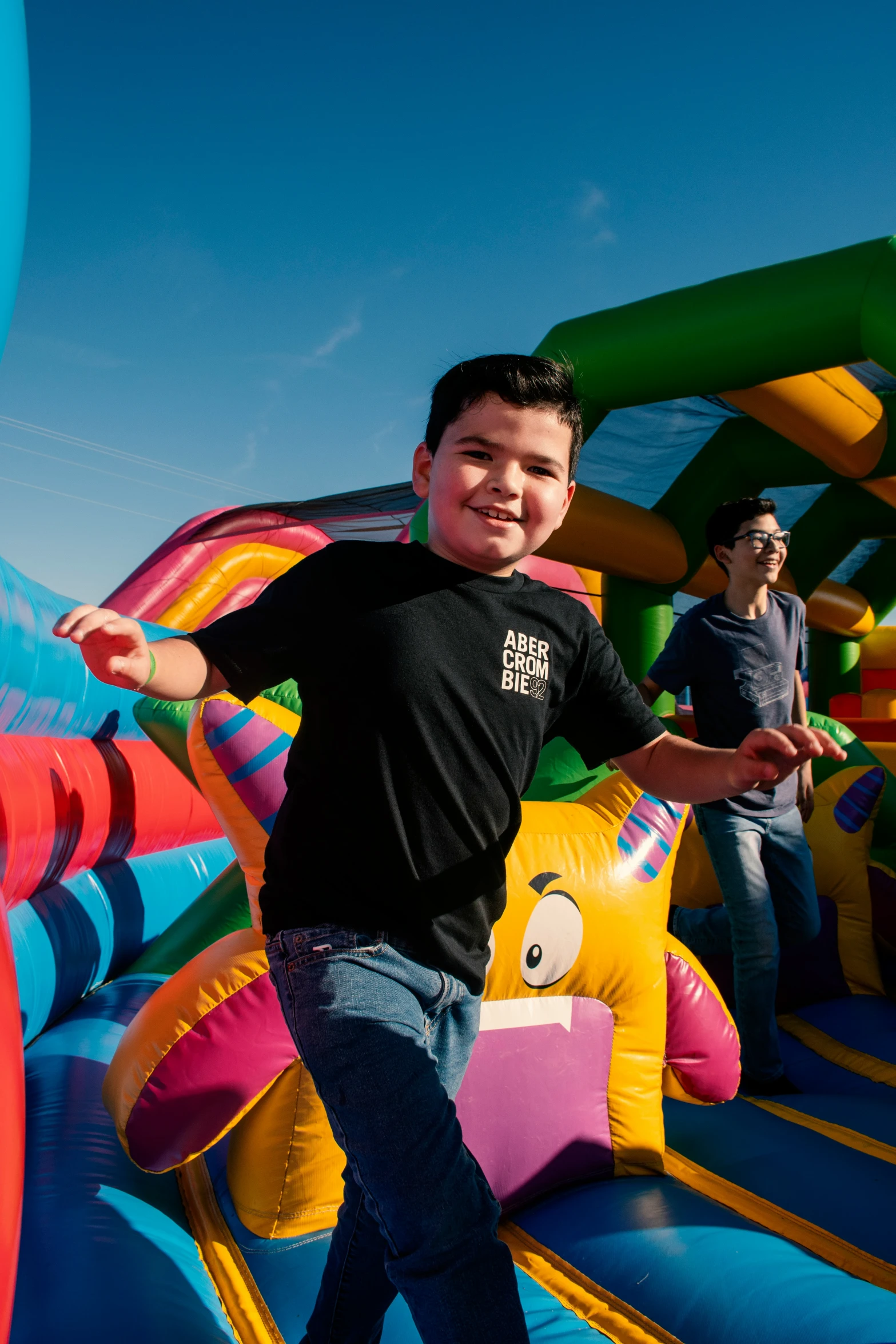 a young man standing on top of a bounce house