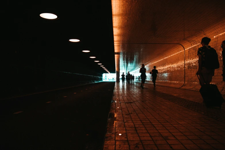 some people are in a tunnel with lights
