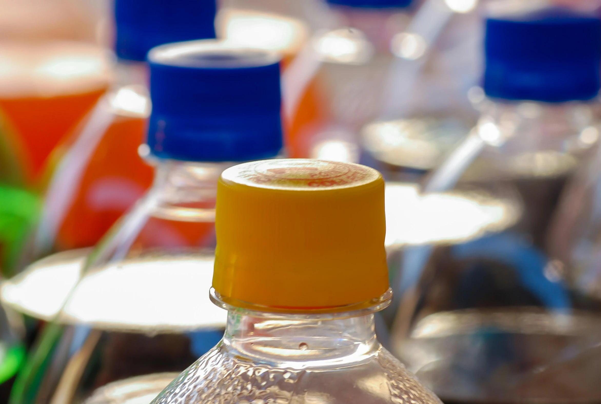 several bottles of alcohol with various colors on top