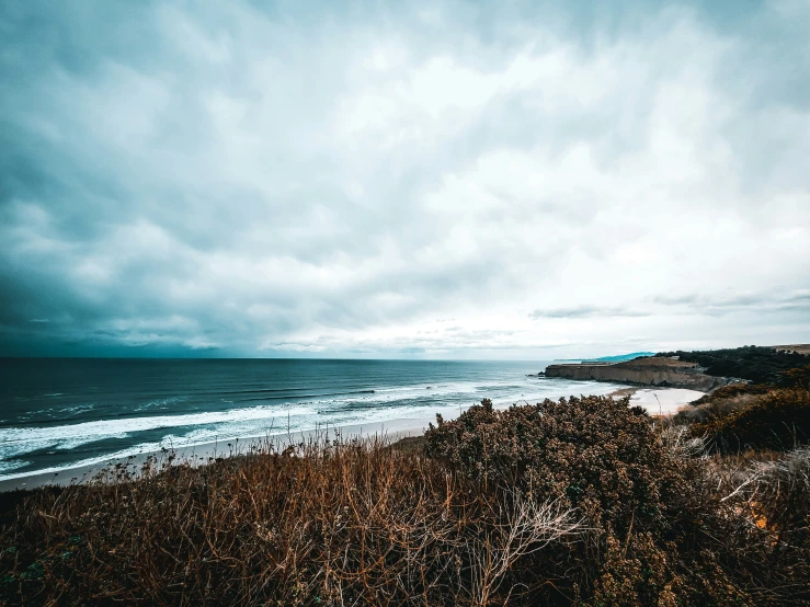 beach and ocean during stormy weather on the horizon