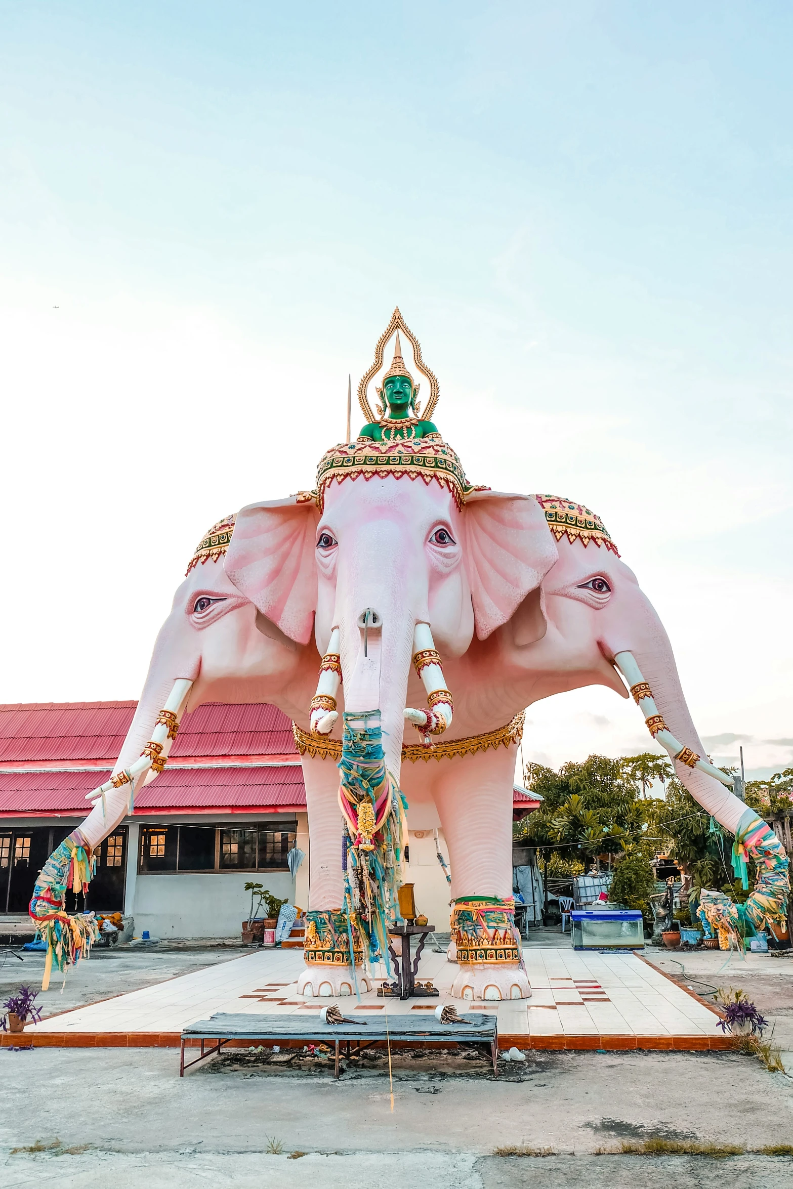 a statue of an elephant standing next to a building