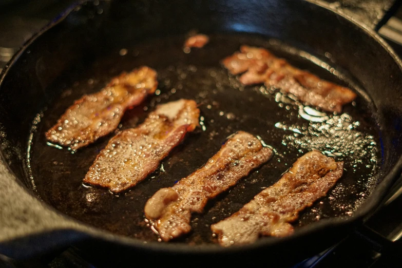 meat cooking in a wok that is not covered