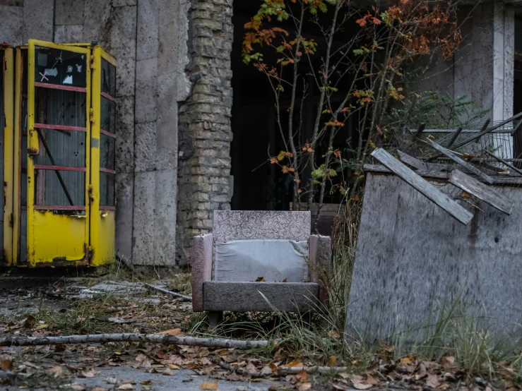 an old chair sitting in front of some old doors