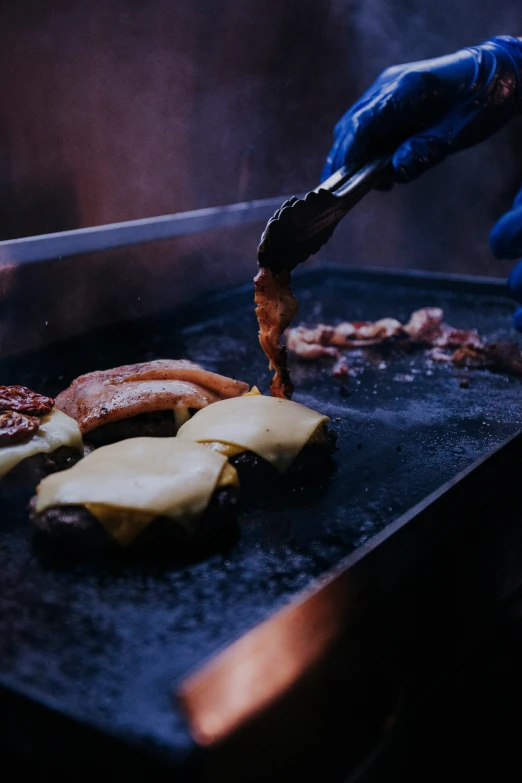 someone preparing food that is on a grill