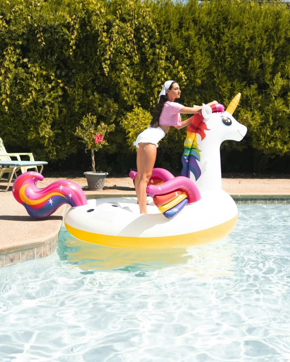 the woman in a swimsuit is riding on a water slide