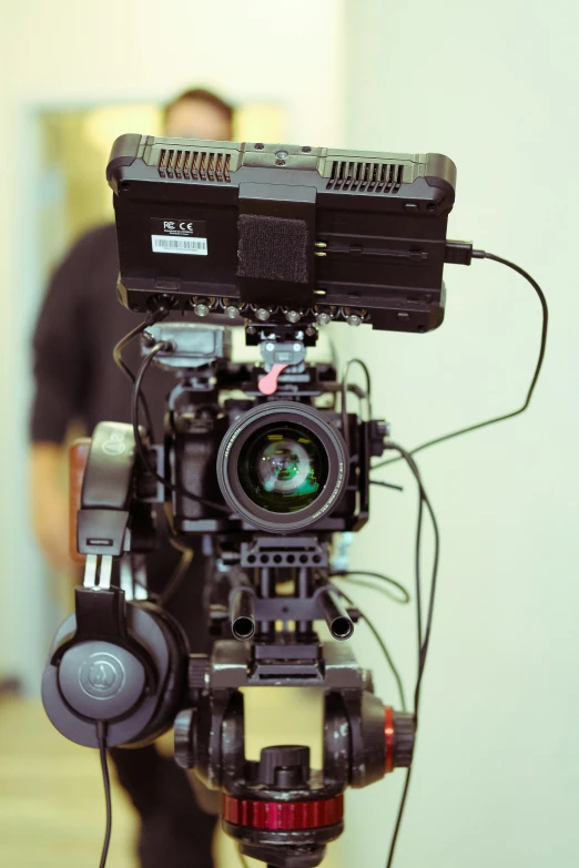 the canon c7 pro attached to a camera, with its arm holding the camera