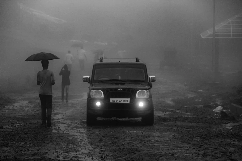 a car is parked on a road in the middle of the fog