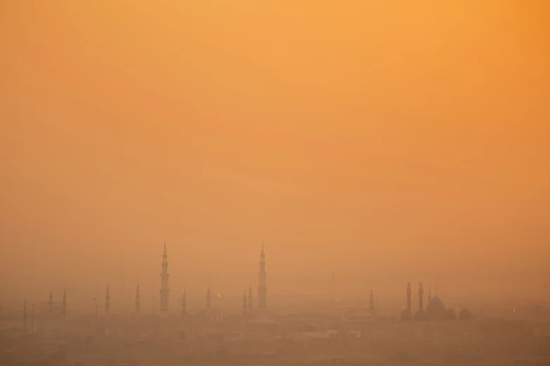 the silhouette of a large clock tower in fog