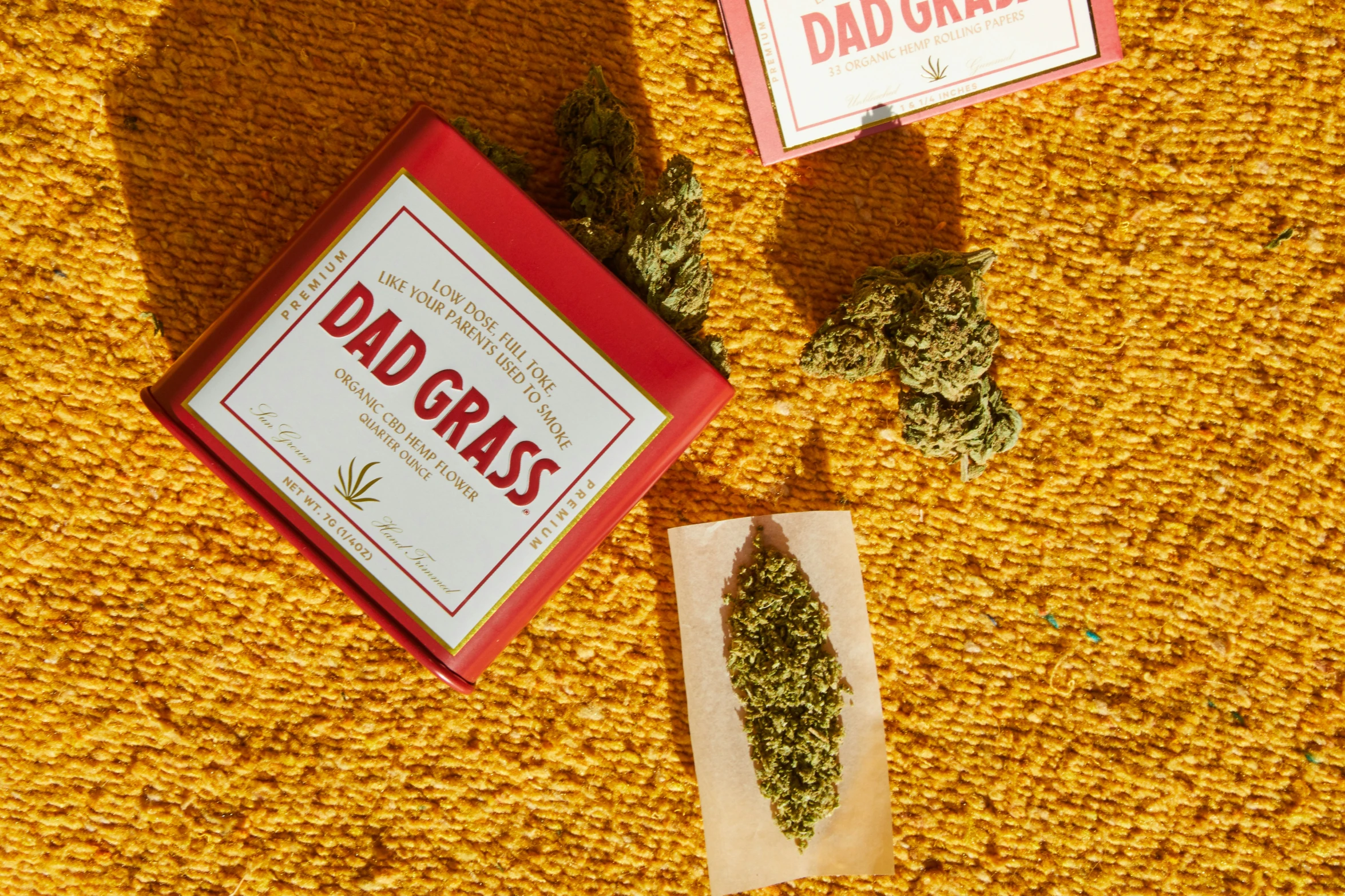 two marijuana buds on a table with the labels