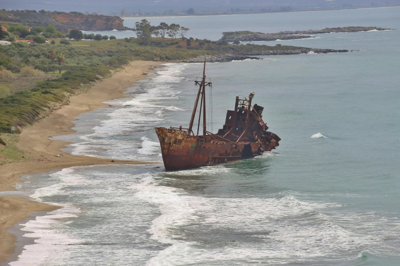 a boat in the water is washed on to the beach