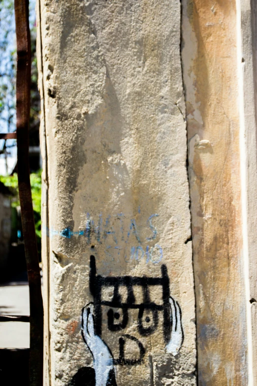 a close up of a wall with graffiti on it