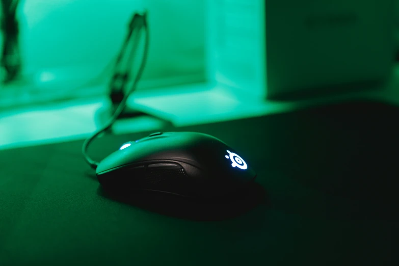 a mouse is illuminated up against a green background