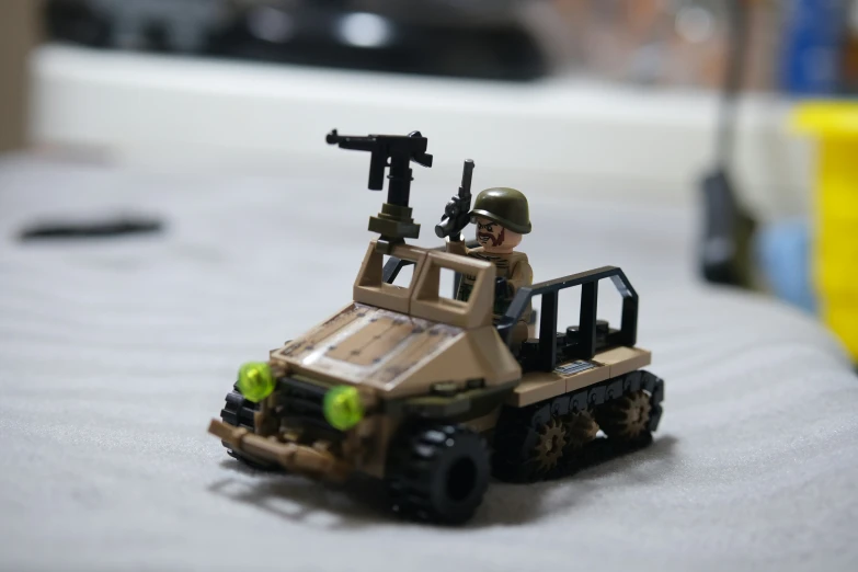a toy soldier with two guns in a toy truck