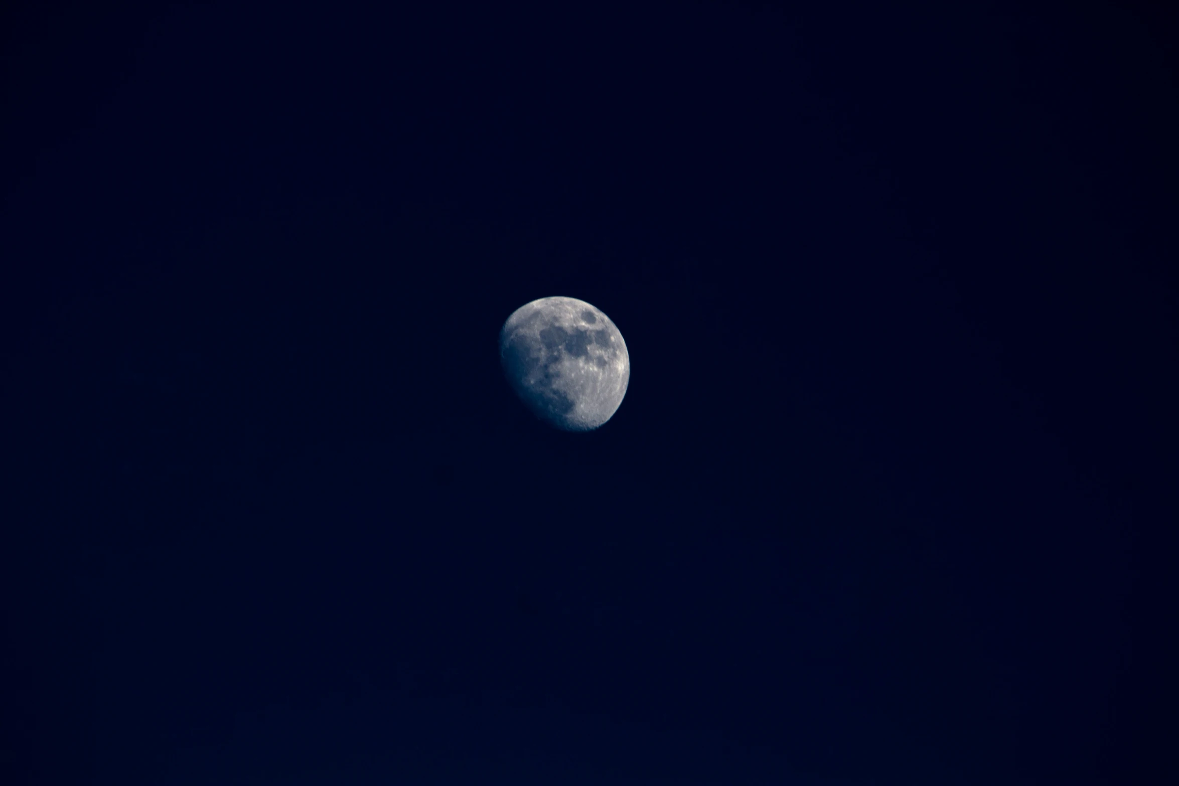 the moon, seen through an airplane window at night