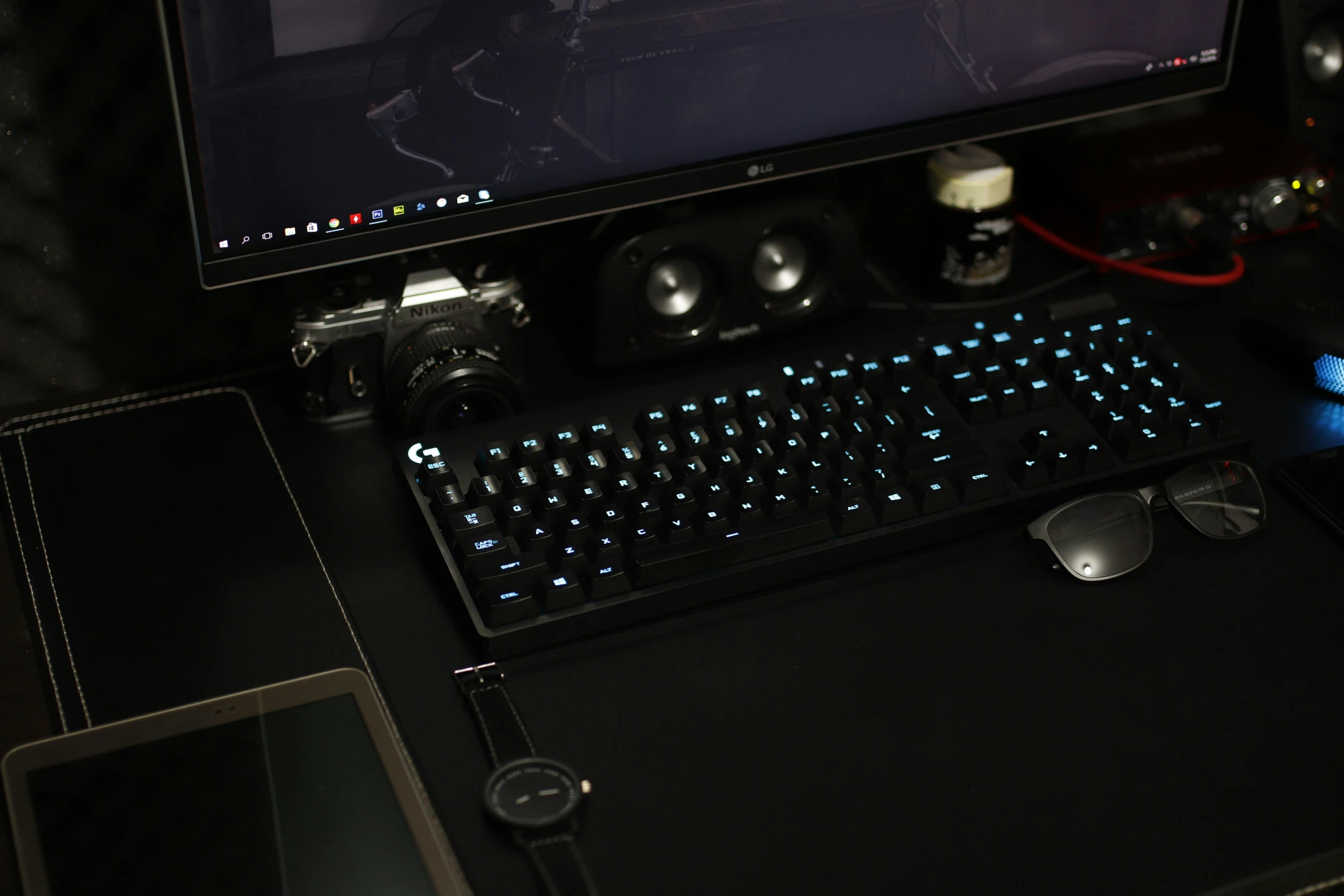 a black keyboard and mouse are in front of a monitor