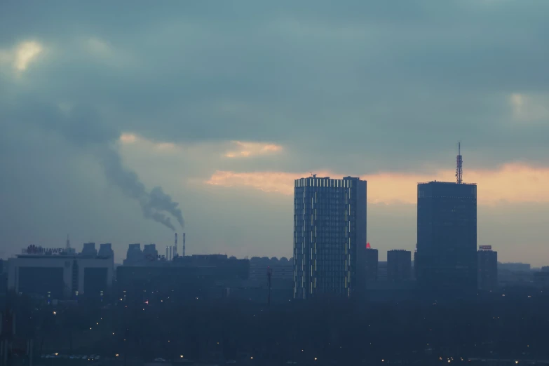 smoke billows from a building near a cityscape