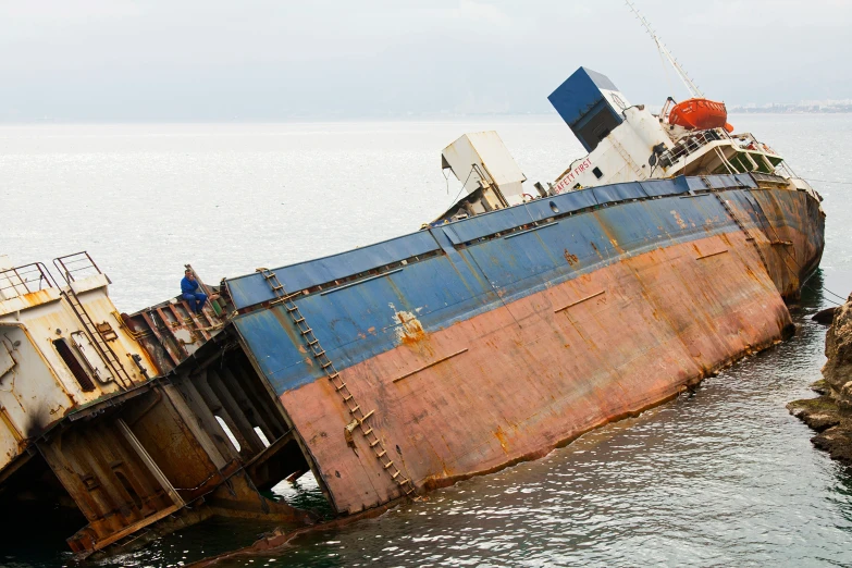 an old rusted ship is anchored in the water