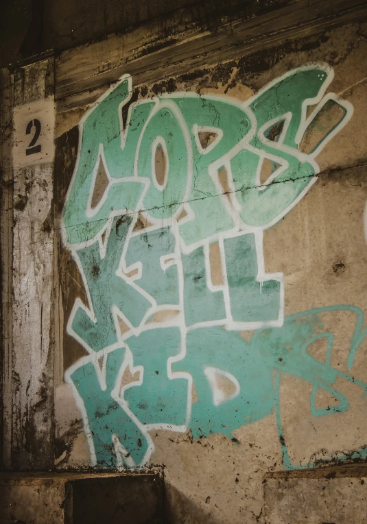 a wall with graffiti on it and a building sign