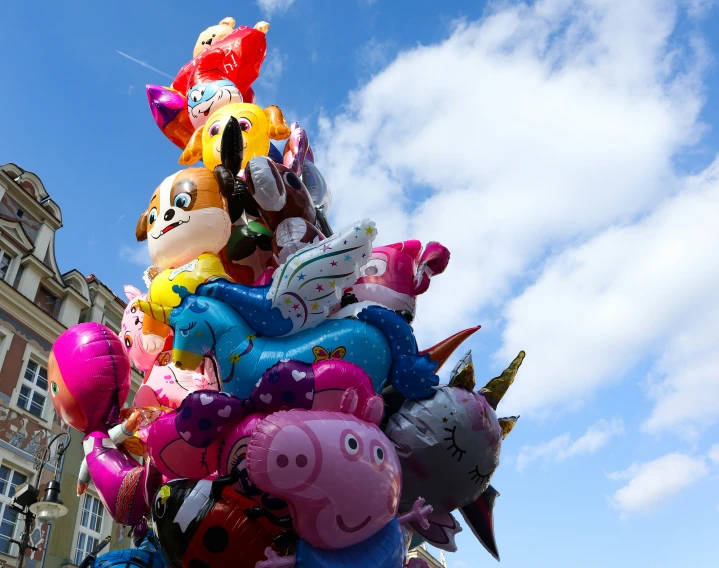 there is a giant balloon tree with many animal balloons on top of it