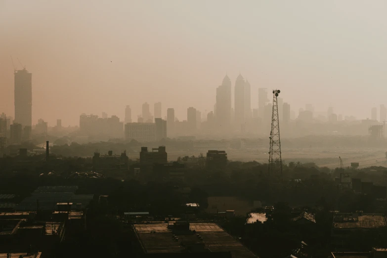 a view of an area with high rise buildings and fog in the sky