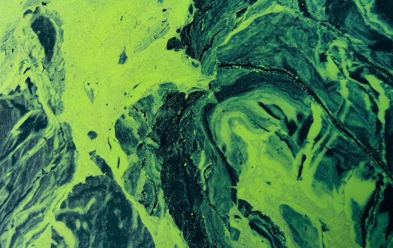 an abstract background shows green, black, and white paint