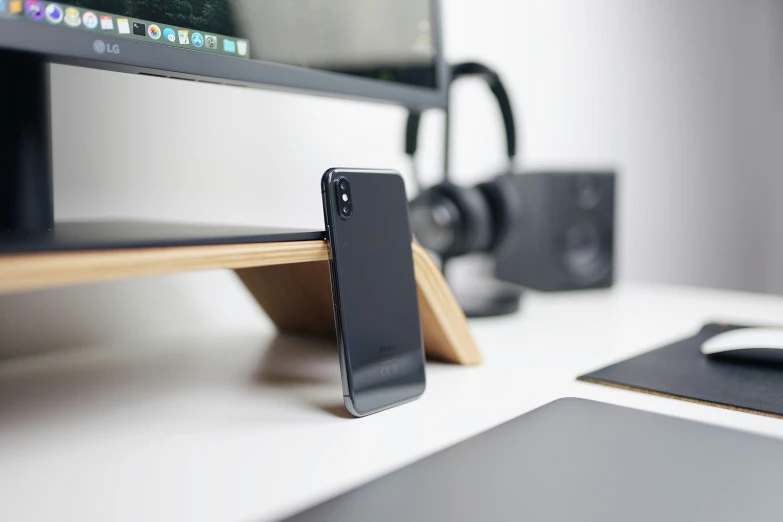 there is an iphone stand in front of the computer screen