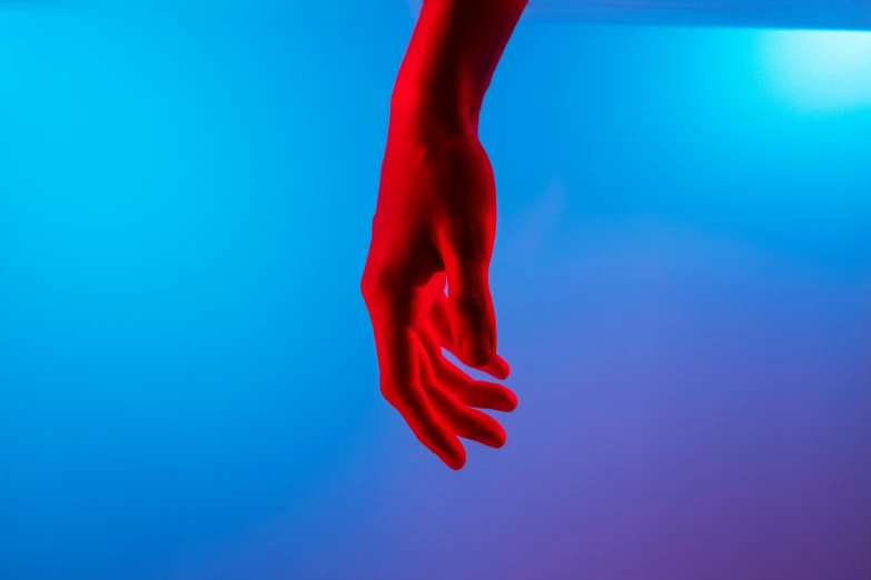 a person's hand reaching up into the ceiling