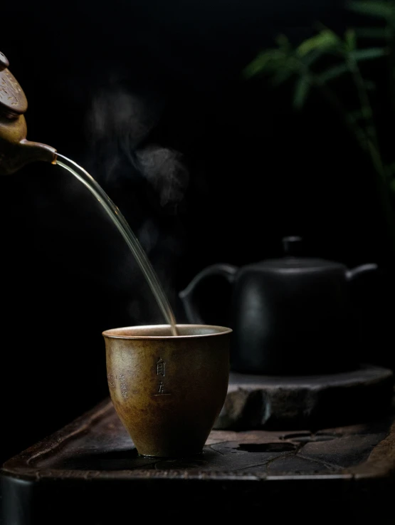 tea being poured into a small tea cup