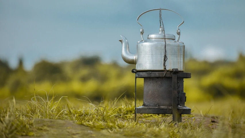 a kettle shaped like an oil pot with a tea kettle sitting on the front of it