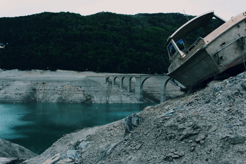 a boat that is sitting on the side of a river