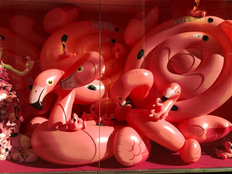a pink display filled with balloons and animals