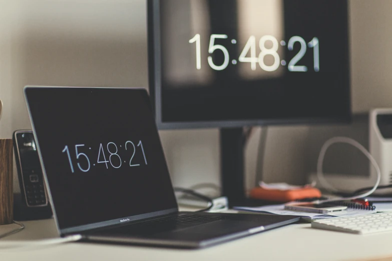 two computer monitors sitting next to each other on a desk