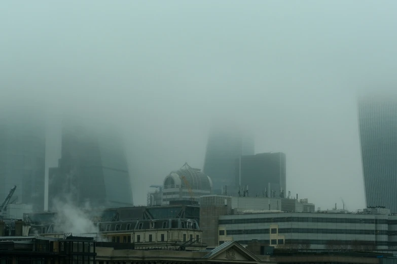 fog looms over a city in the distance