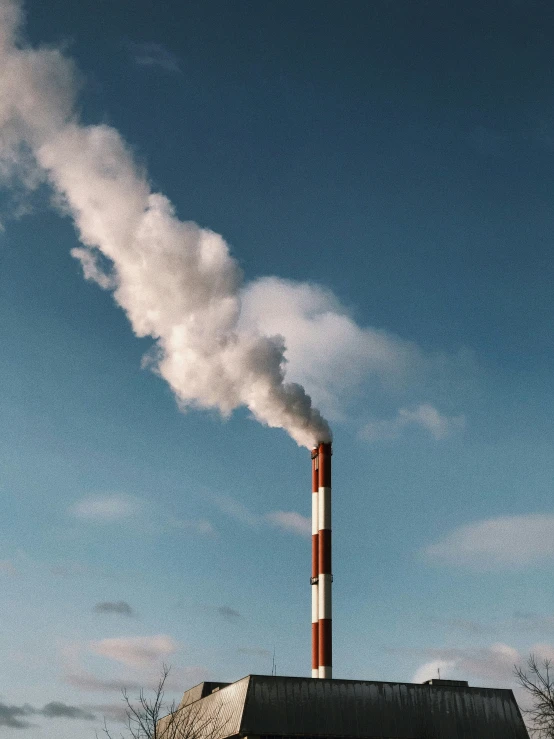 there is a smoke stack that emits steam into the air