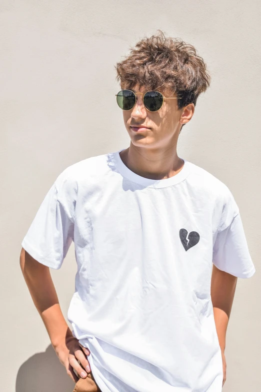 a boy wearing sunglasses posing for a po