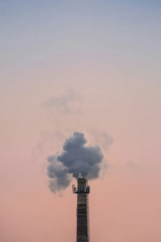 a smoke plume is seen coming out of the top of a building