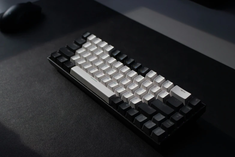 the front of a computer keyboard with a silver, black and gray top