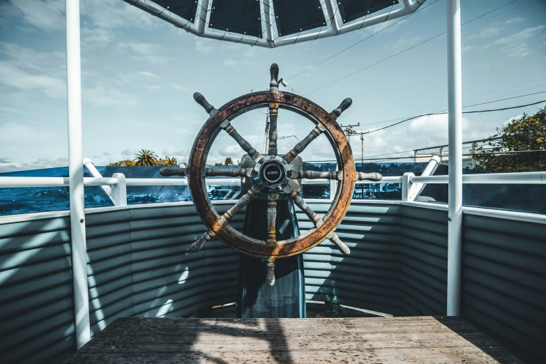 an empty wooden table sits in the center of a ship