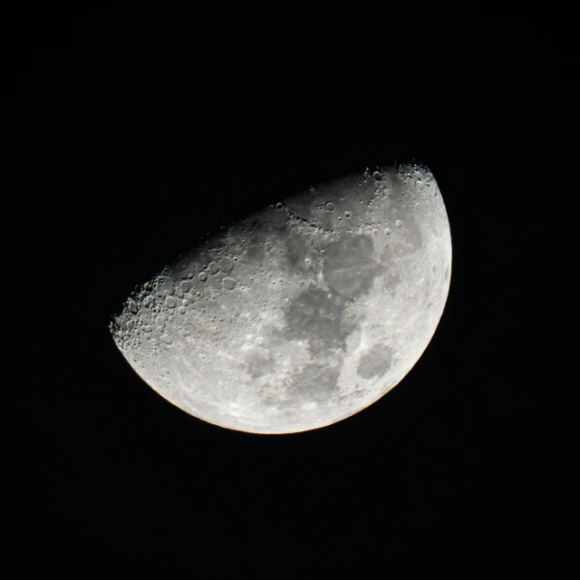 a crescent of the moon that is partially illuminated by the night sky